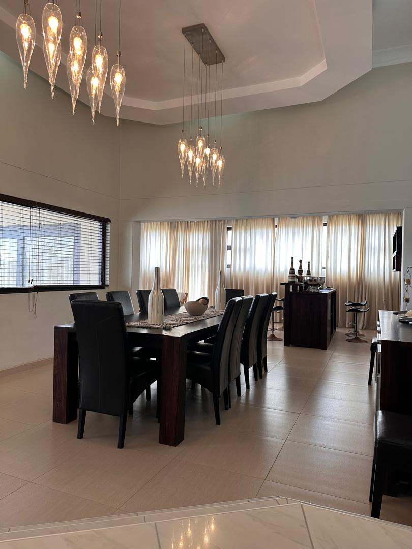 Dining area with pendant lighting and large windows